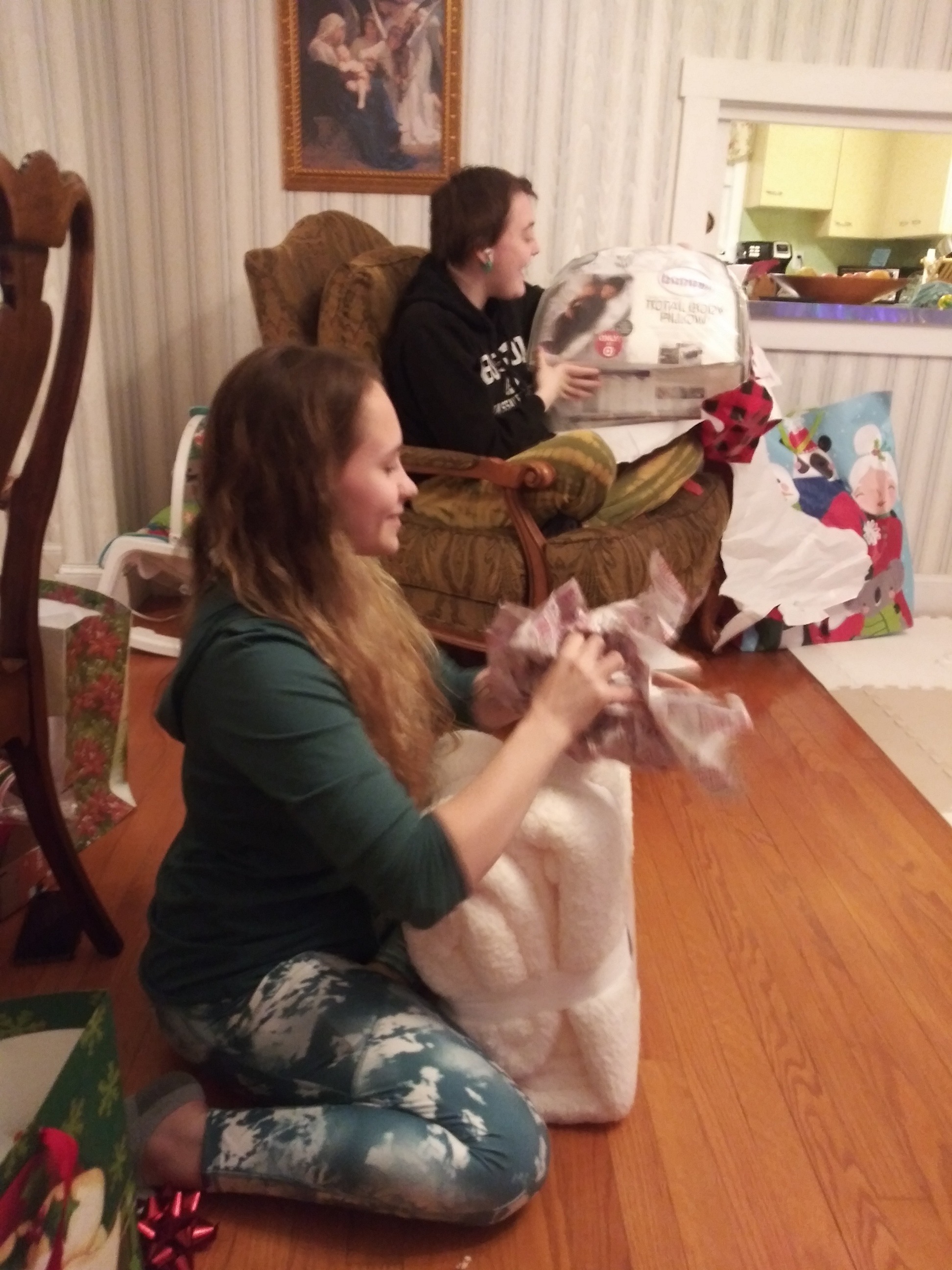 Picture of two women opening Christmas gifts