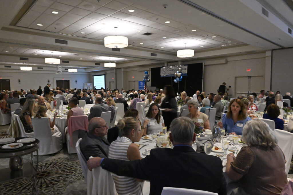 A banquet hall with people sitting at tables