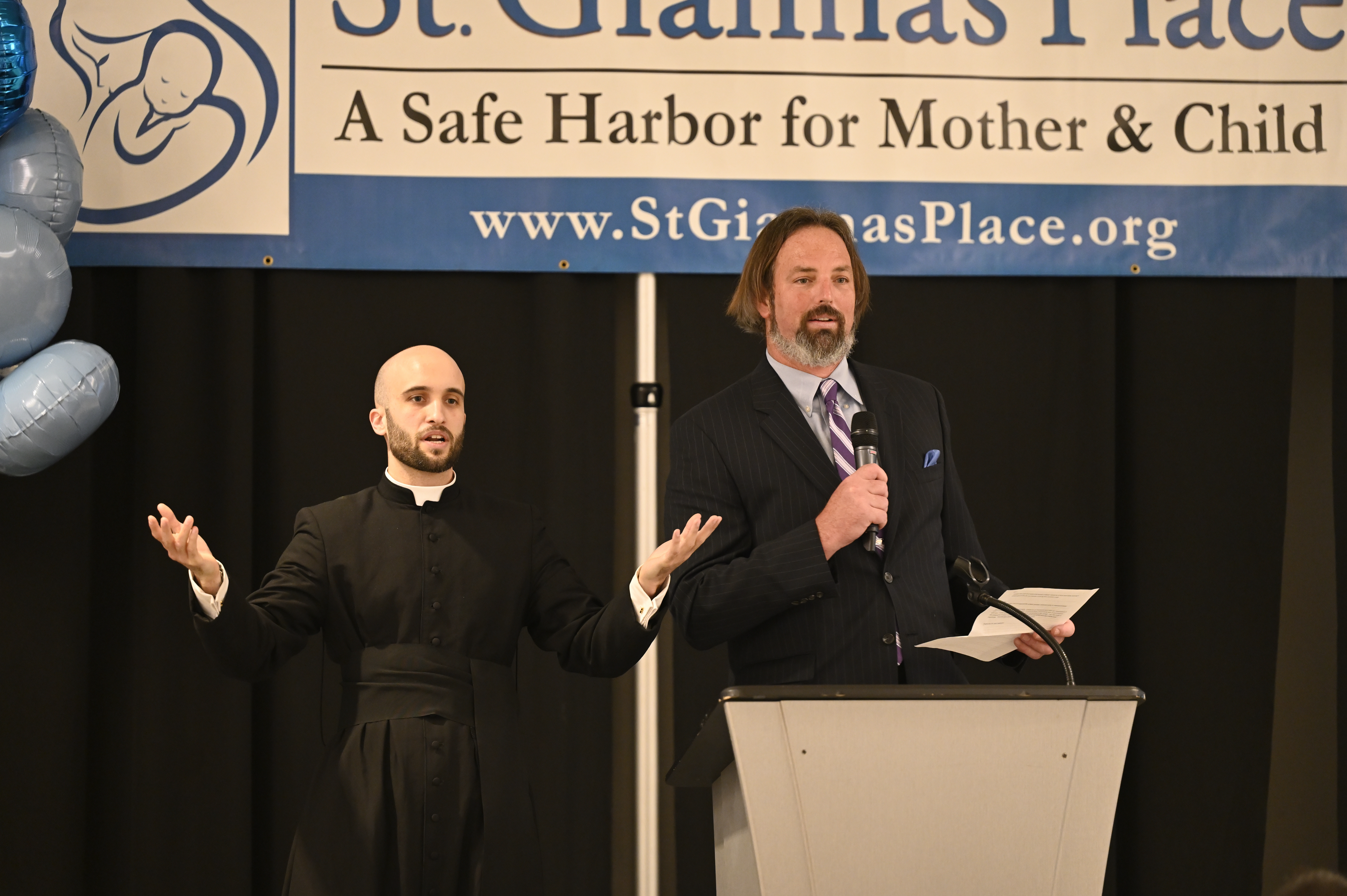 Fr. Rory and the auctioneer on stage